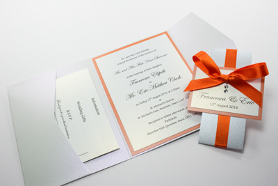 Handmade pocketfold wedding invitations in white and flame orange