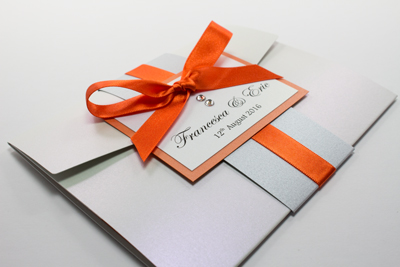 Bespoke pocketfold wedding invitation in moonstone with flame orange ribbon